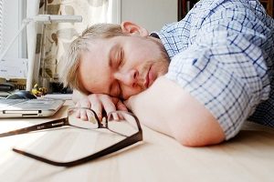 guy sleeping at desk